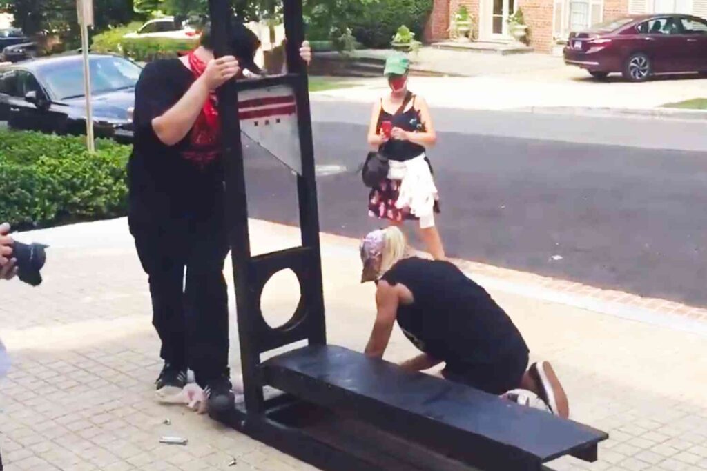 Protesters build guillotine in front of Jeff Bezos' house.